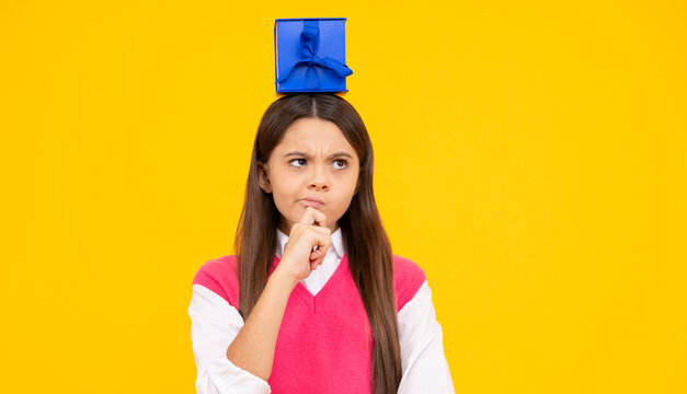 Teen girl hold gift box. Child holding gift box in Christmas or birthday. Girl with giftbox for mothers day. Portrait of a little girl with a gift on isolated background. Birthday, presents gift.