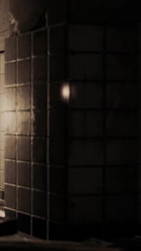 A wall of tiles catches light from a source in a room. The setting gives off a warm glow, showing shadows and texture on the surface. This takes place in the evening.