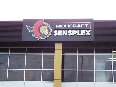 Gloucester, Ontario, Canada &ndash; August 03, 2025: A Richcraft Sensplex sign featuring the "Ottawa Senators logo" sits above large glass windows on a modern sports facility building  on Shefford Road.   