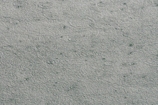 Rain on calm grey water, abstract full frame background, Lake Lucerne, Switzerland