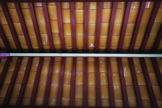 Red and yellow painted wooden roof beams of a Chinese pavilion, Chinese Garden Zurich, Switzerland
