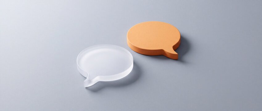 Two speech bubble icons, one clear and translucent, the other orange and textured, symbolizing communication, ideas, and conversation on a gray background