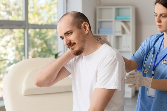 Chronic neck pain and physical therapy, doctor examining patient with muscle injury in medical clinic for rehabilitation and orthopedic health care