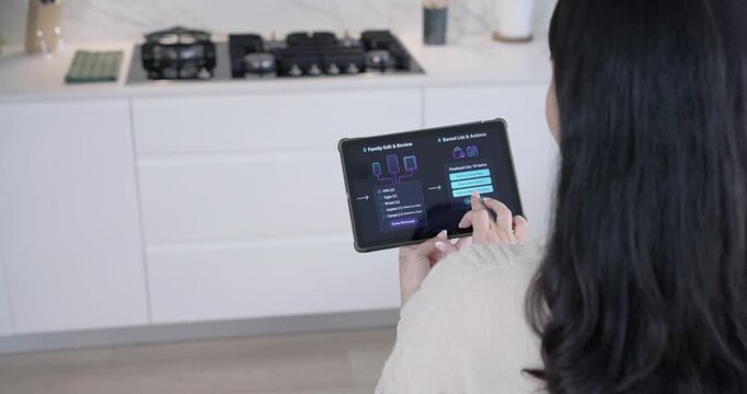 Adult woman tapping menu and updating shopping list on tablet at kitchen counter, copy space