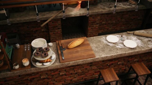 Delicious breads and pastries lay invitingly on a wooden counter in a charming bakery. Flour dust and baking tools create a warm, artisanal atmosphere filled with promise.