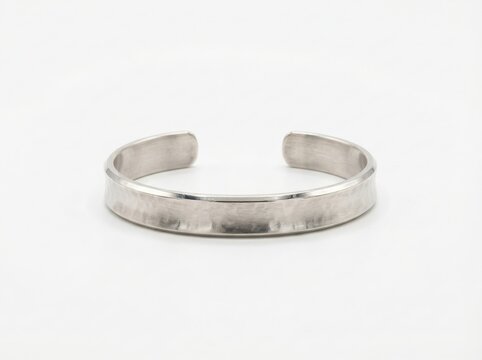 Simple open silver toe ring on white background with flat lay still life accessory ornament precious boutique collection close up studio shot isolated minimalist commercial top view