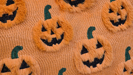 close up orange fuzzy halloween pumpkin fabric pattern macro texture background  © Rungphailin