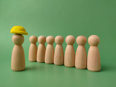 Wooden Figures with Yellow Hard Hat Leader