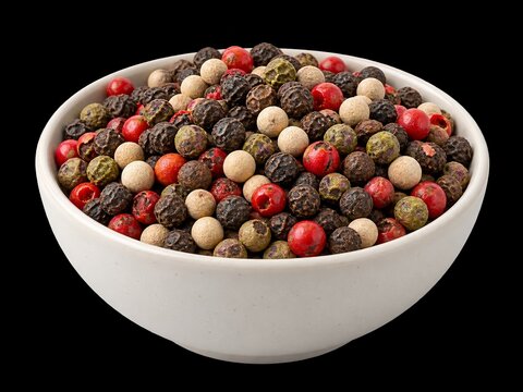 Mix of whole peppercorns in white ceramic bowl isolated on black background high quality culinary spice ingredient food photography