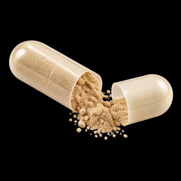 open beige supplement capsule spilling fine powder