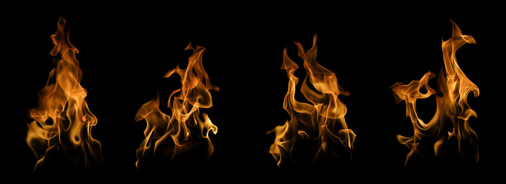 Collection of four realistic vertical fire flames isolated on a black background. Concept of abstract fiery element set, burning warmth, dynamic heat overlay, and blazing bonfire design.