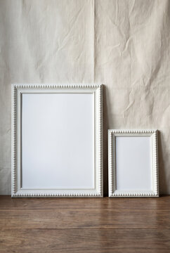 Rustic still life with two blank white picture frames