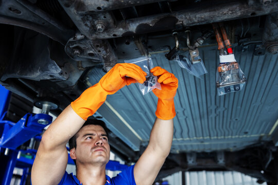 Technician Inspecting a Plastic-Wrapped EV Electrical Connector During Repair