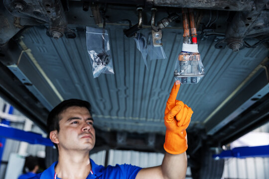 Technician Inspecting a Plastic-Wrapped EV Electrical Connector During Repair