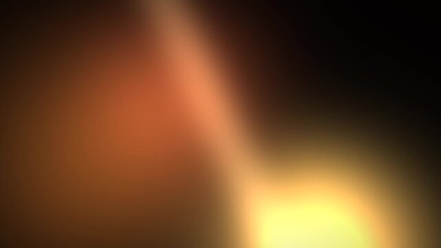 Warm golden light leaks drifting over dark cinematic background loop