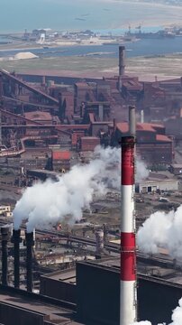 Vertical aerial view of a large steel production facility in Dunkirk, France, showing heavy industry, metal processing and industrial manufacturing infrastructure.
