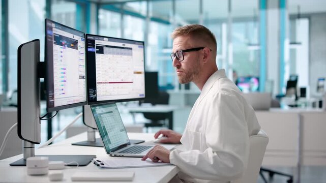 Pathologist Studies Test Results On Laptop