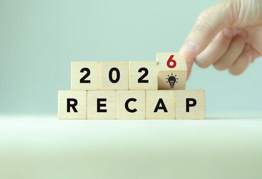 2026 Year in Review. Annual Recap, Business Insights and Innovation. Placing a 2026 wooden block with a lightbulb icon above RECAP letter blocks. Annual review, business reflection, year-end insights.