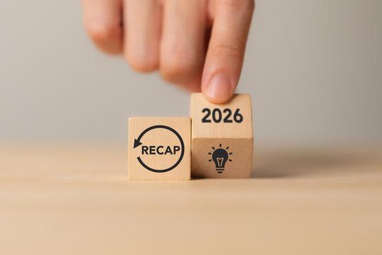 2026 Year in Review. Annual Recap, Business Reflection, New Ideas. Placing a 2026 wooden block above a lightbulb icon beside a recap symbol. Year-end review, reflection, key insights, future planning.