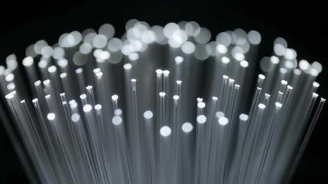 Fiber optic cable strands glowing with bright white light transmitting data in dark network environment 4K Generative AI