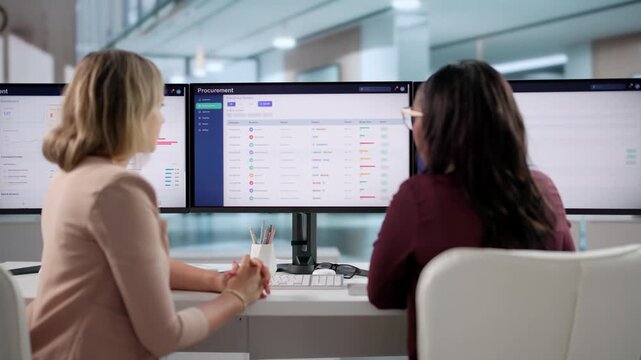 Procurement Manager And Assistant Reviewing Supplier Data