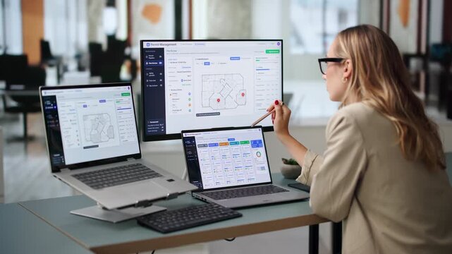 Municipal Permit Manager Reviews Online Application Using Computer