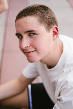Portrait of a teenage boy with blue eyes and a buzz cut