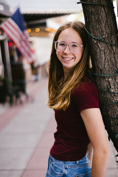 Smiling teenage girl with freckles on a city street