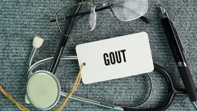Stethoscope and paper with the word Gout is a common and painful form of inflammatory arthritis caused by excess uric acid in the blood that forms sharp crystals in your joints
