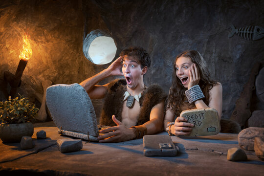 Prehistoric Couple Amazed by Online Shopping Deal