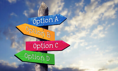 Option A, B, C or D - wooden signpost with four arrows, sky with clouds © PX Media