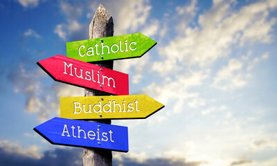 Catholic, Muslim, Buddhist, Atheist - wooden signpost with four arrows, sky with clouds © PX Media