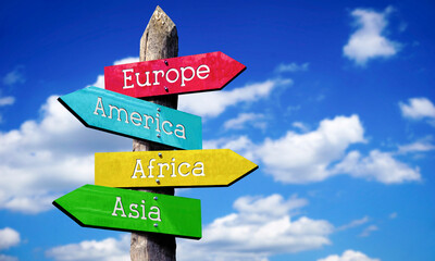 Europe, America, Africa, Asia - wooden signpost with four arrows, sky with clouds © PX Media