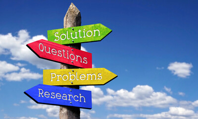 Solution, questions, problems, research - wooden signpost with four arrows, sky with clouds © PX Media