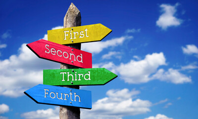 First, second, third, fourth - wooden signpost with four arrows, sky with clouds © PX Media