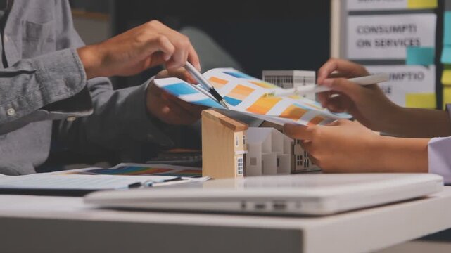 Business professionals meet with real estate agents to discuss real estate investments, sign contracts, apply for mortgages, plan purchases, ownership, and successfully secure approval for