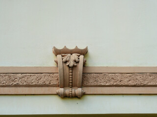 String course with a decorative bracket on a historic plaster facade. The minimal composition provides ample space for text. Copyspace. © Frank
