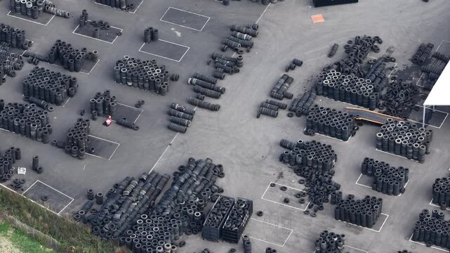 Aerial view of organized stacks of used tires at a recycling and storage facility in Hombourg, Grand Est, France.