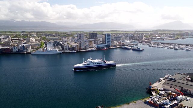 Arrival of MF Landegode ferry boat in Bodo city harbor, aerial tracking