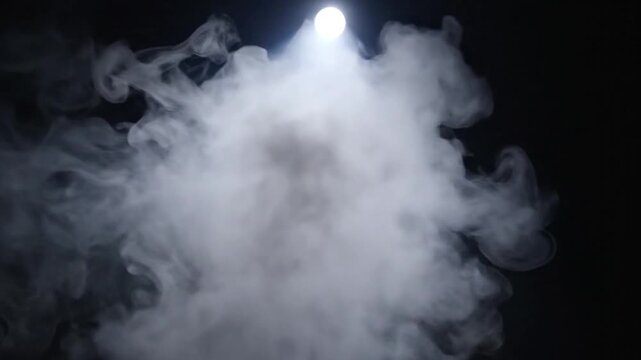 Spotlight Shrouded Scene Creating Misty Atmosphere in Dark Studio