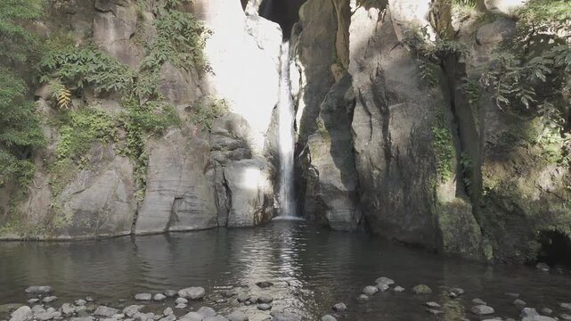 Salto do cabrito waterfall flowing into natural pool with a couple raising arms