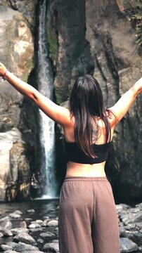 Woman embracing nature at salto do cabrito waterfall