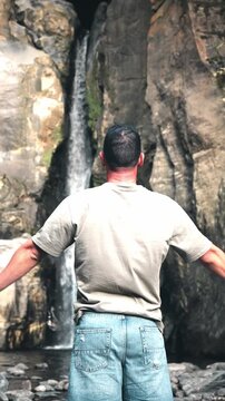 Adult male embracing nature at salto do cabrito waterfall