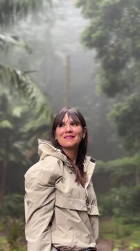 Woman exploring misty forest on sao miguel island