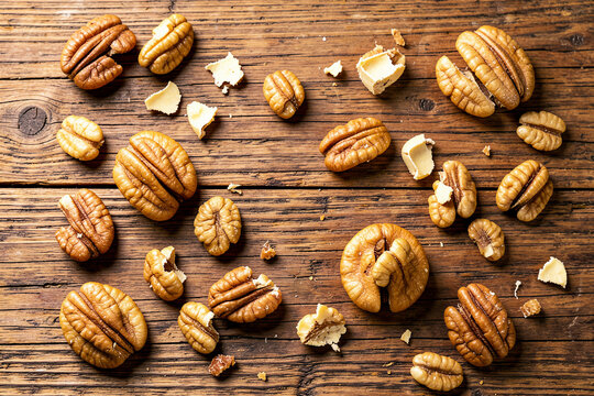 Rustic Pecan Halves Flat Lay on Weathered Wooden Background