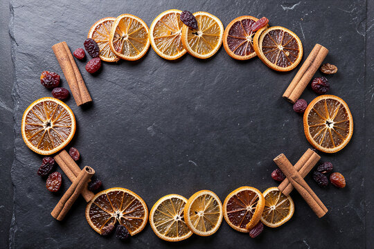 Dehydrated Orange Slices Cinnamon Sticks And Raisins Slate Flat Lay