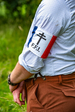 A participant wears a tricolor FFI armband during the historic D-Day commemorations in Hermanville, Calvados.