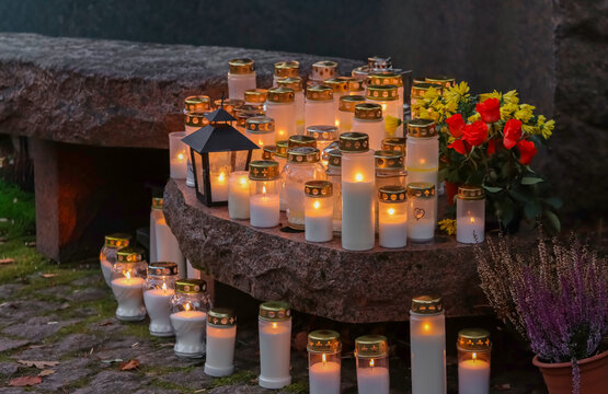 All Saints' Day candles burn at the memorial site in the cemetery as the November evening grows dark. A Finnish way of remembering the departed in the churchyard.