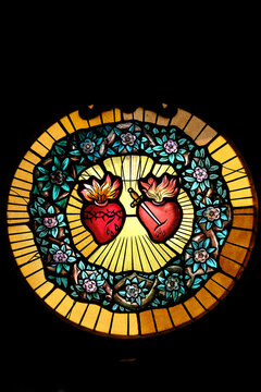 Carmel of Lisieux. A circular stained-glass window depicts the Sacred Heart of Jesus and the Immaculate Heart of Mary, surrounded by a wreath of flowers