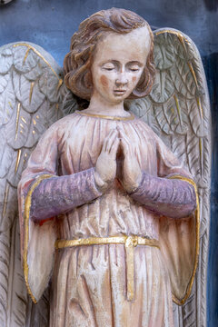Yonne, Burgundy, France. A polychrome wooden statue of an angel in prayer with hands clasped, in the Church of Saint John the Baptist in Joigny, Yonne.